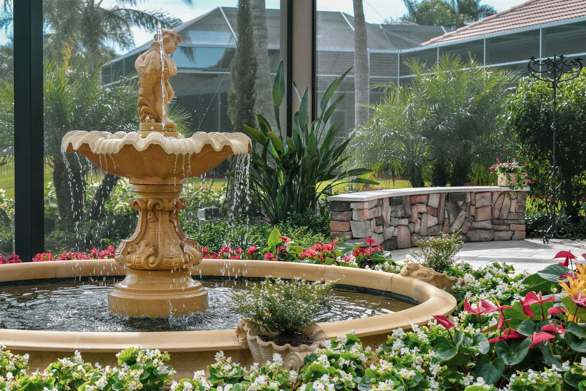 Formal fountainscape with bubbling water feature and landscape lighting — luxury
